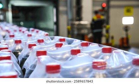 Plastic bottles in packages. Drinks packaged in plastic bottles and wrapped in thick film in a warehouse at a grocery store.