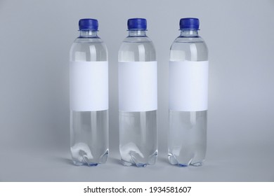 Plastic bottles with soda water on light background