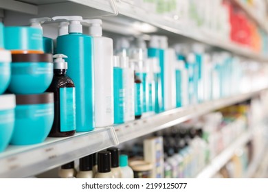 Plastic Bottles Of Various Hair Care Products On Shelves Of Cosmetics Store