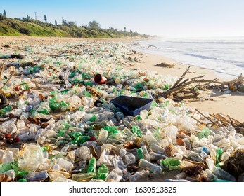 Plastic bottles and waste washed up on a beach  by the incoming tide, covering the entire beach at Umkomaas in KZN, South Africa