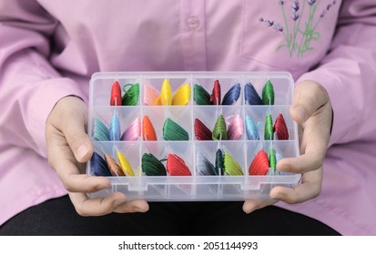 Plastic Box With The Embroidery Threads Is In Female Hands, Close-up.