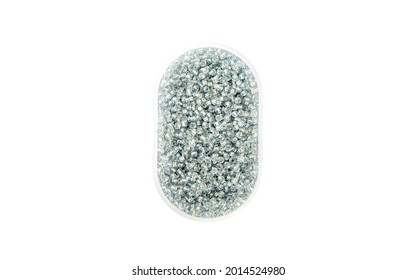 Plastic box with transparent round beads isolated on white background. Top view. Copy space.