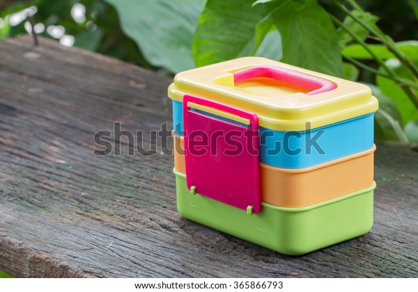 Plastic boxes for food on the old wooden\
floor.Plastic\
containers