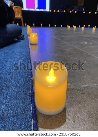 plastic candles filled with yellow LED lights lit up in the common prayer room