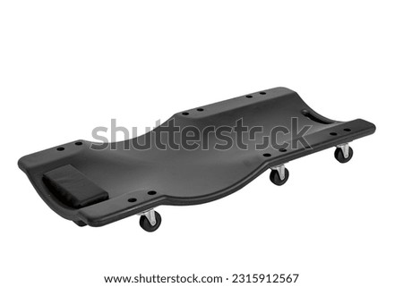 plastic car creeper or deck chair of black color isolated on a white background
