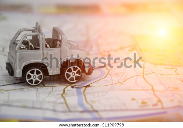 plastic car\
toy background map  to travel\
concept.