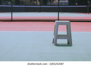 Plastic Chair In Tennis Field