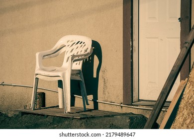 Plastic Chairs Outside Rundown Building