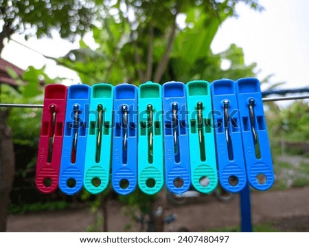 Plastic Clothespin on a clothes hanger. Colored old cloth clips on a clothesline