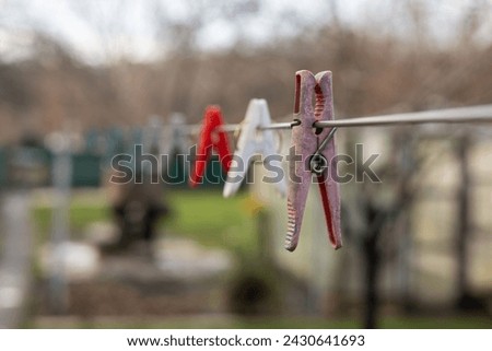 Plastic Clothespin on a hanger. Colored old cloth clips on a cloth rope