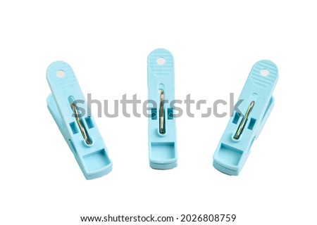 Plastic clothespins in a row isolated on a white background