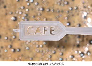 Plastic Coffee Spoon Over Coffee Foam
