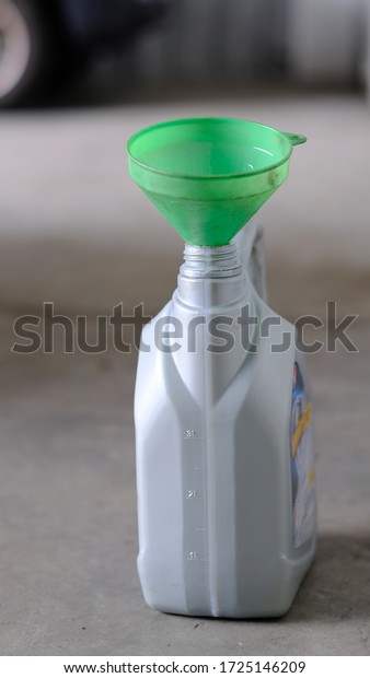 Plastic Cone\
Funnel with Engine Oil\
Lubricant.