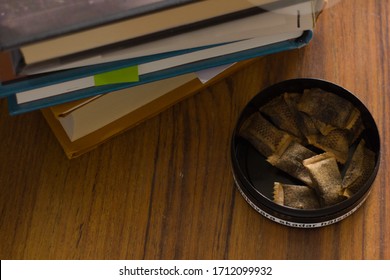 Plastic Container Filled With Smokeless Moist Tobacco. Translation For Swedish Warning Label/text: This Tobacco Product Seriously Damages Your Health.