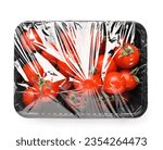 Plastic container of fresh tomatoes wrapped with stretch wrap on white background