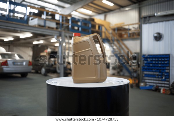 Plastic\
container for motor oil in car repair\
shop
