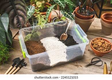 Plastic container with the soil mixing ingredients, peet moss, perlite, gardening soil, and coco husk chips. - Shutterstock ID 2245121015
