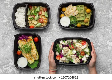 Plastic containers with delicious take away food on gray background, top view