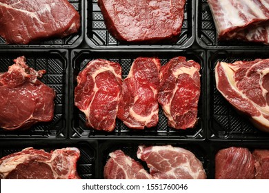 Plastic containers with fresh raw meat as background, top view - Powered by Shutterstock