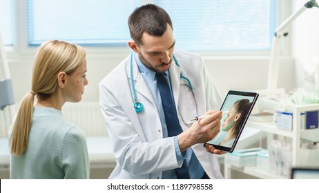 Plastic / Cosmetic Surgeon Consults Woman about Facial Lift Surgery, He Draws Arrows on Digital Tablet Computer Screen, Showing Types of Facelift and Nose Correcting Procedures Available for Her.