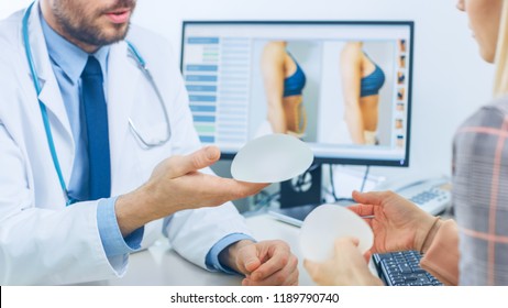 Plastic / Cosmetic Surgeon Shows Female Patient Breast Implant Samples for Her Future Surgery. Professional and Famous Surgeon Working in Respectable Clinic. - Shutterstock ID 1189790740