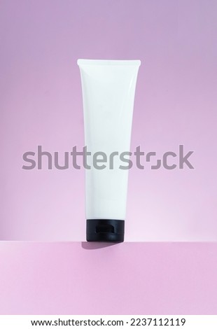 Plastic cosmetic white tube for cream or gel mockup on pink background