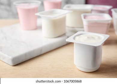 Plastic Cup With Tasty Yogurt On Table