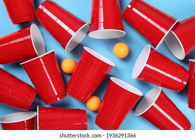 Plastic Cups And Balls For Beer Pong On Light Blue Background, Flat Lay