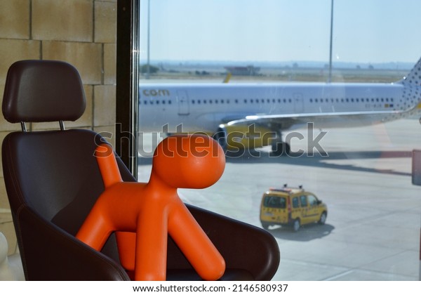 Plastic dog and a car and plain at the\
background. Spain. Airports.\
Transportation