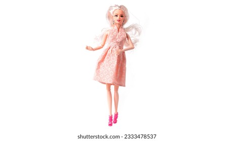 Plastic doll in dress isolated on white background. High quality photo