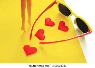 Plastic Doll Girl's Legs , Hearts And Sunglasses, Travel And Beauty Concept. Minimal Funny And Quirky Design Still Life