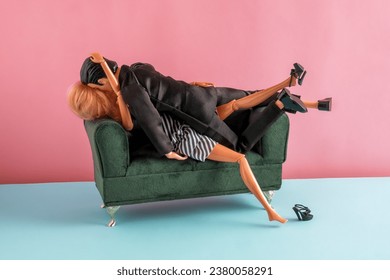 Plastic dolls making love on couch. Sex concept.