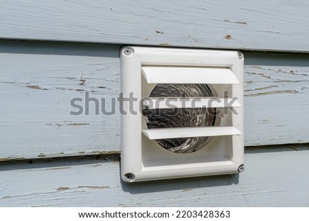 Plastic dryer exhaust vent with open flaps while dryer is on