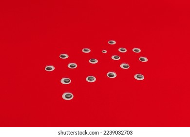 Plastic eyes for decor on a red background