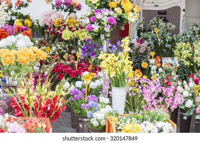 Plastic flowers for sale at the weekly outdoor market - Shutterstock ID 320147849
