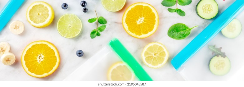 Plastic Food Storage Bags With Fresh Summer Fruit And Vegetables Panorama, Shot From Above On A White Marble Kitchen Table. Summer Produce In Zip Lock Containers