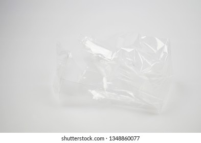 Plastic food wrap crumpled on grey background - Shutterstock ID 1348860077