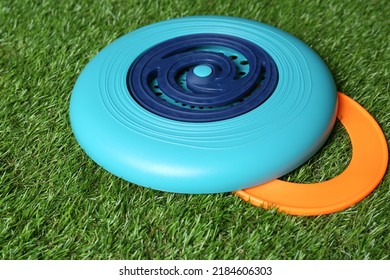 Plastic Frisbee Disk And Ring On Green Grass, Closeup