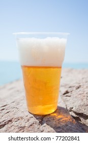 Plastic Glass Of Beer On Rock