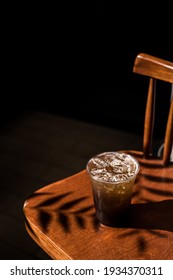 plastic glass of iced coffee with sparkling soda on the table