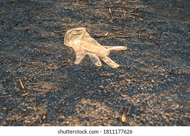 Plastic Gloves From A Supermarket Abandoned On The Ground In A Park, Polluting.