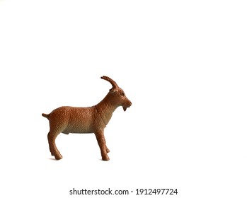 A Plastic Goat On A White Background