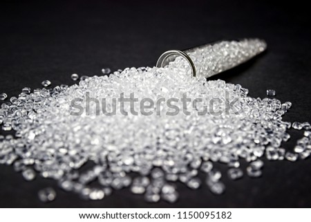 Plastic in granules. Polymer pellets. Isolated on a black background.