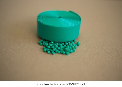 The plastic granules. Polymeric of green dye . Dye for plastics in granules. Green granules of polypropylene or polyamide. background. Plastics and polymers industry. - Shutterstock ID 2253822573