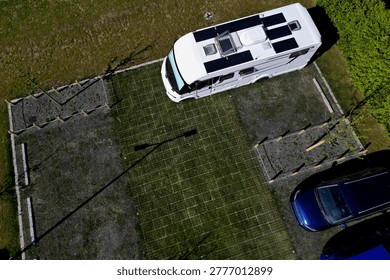 Plastic Grid Systems system made from recycled plastics that reinforce  ground for parking walkways.Stormwater Management permeable, allowing rainwater to soak into ground rather running off into sewers,  prevent flooding.  heavy loads, making them ideal for green parking lots, driveways, high-traffic pedestrian paths.