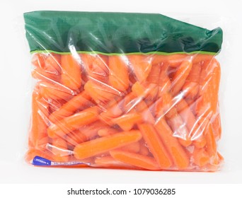 Plastic grocery store bag filled with healthy baby carrots. No Label.