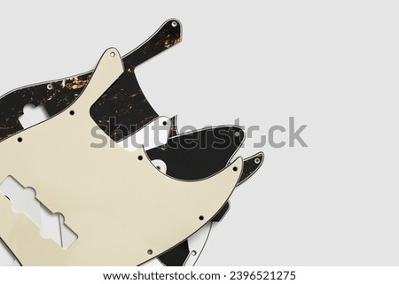 Plastic guitar pickguards on white background