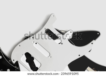 Plastic guitar pickguards on white background. Music instrument