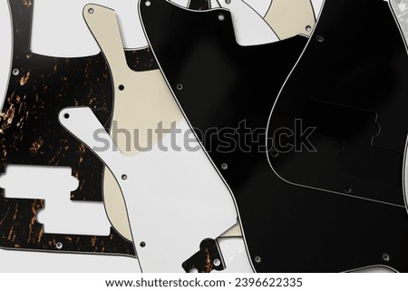 Plastic guitar pickguards on white background. Music instrument