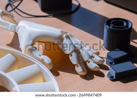 Plastic hand printed on 3D printer. Human arm prosthesis created on a 3D printer from molten plastic. Plastic hand, fingers, nails printed on 3D printer. Modern new additive 3d printing technologies